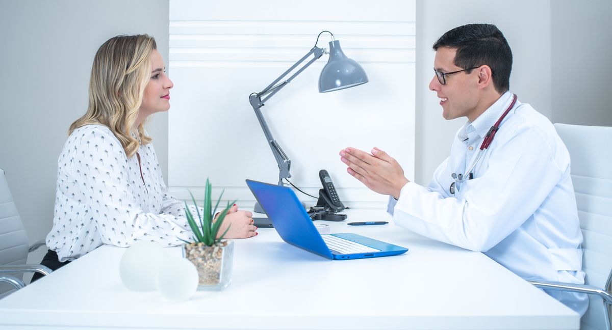 Doctor conducts a patient consultation in a bright modern medical office