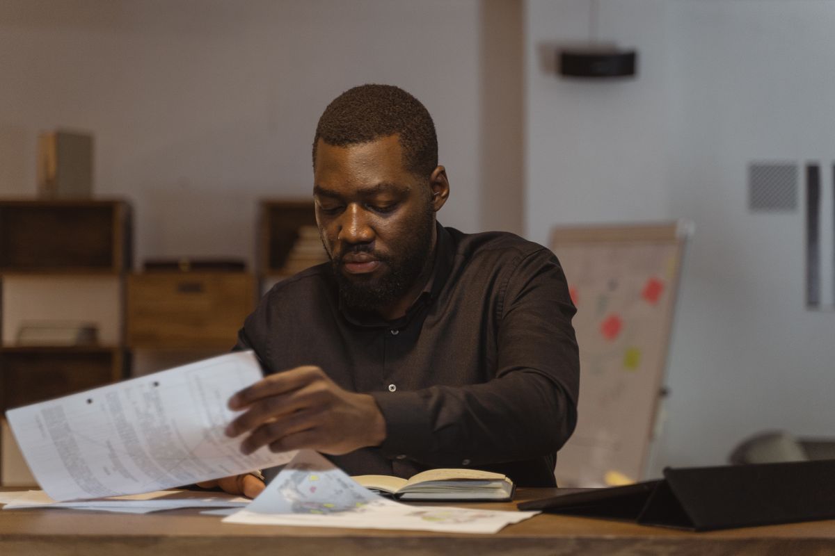 Man at a table going through his papers