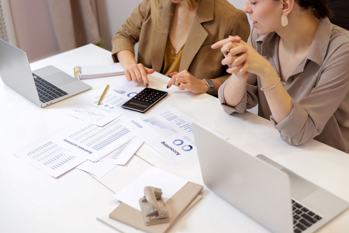 Two professionals collaborating on financial documents