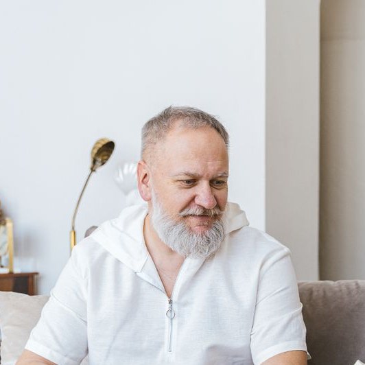 A healthcare professional consulting with an elderly man